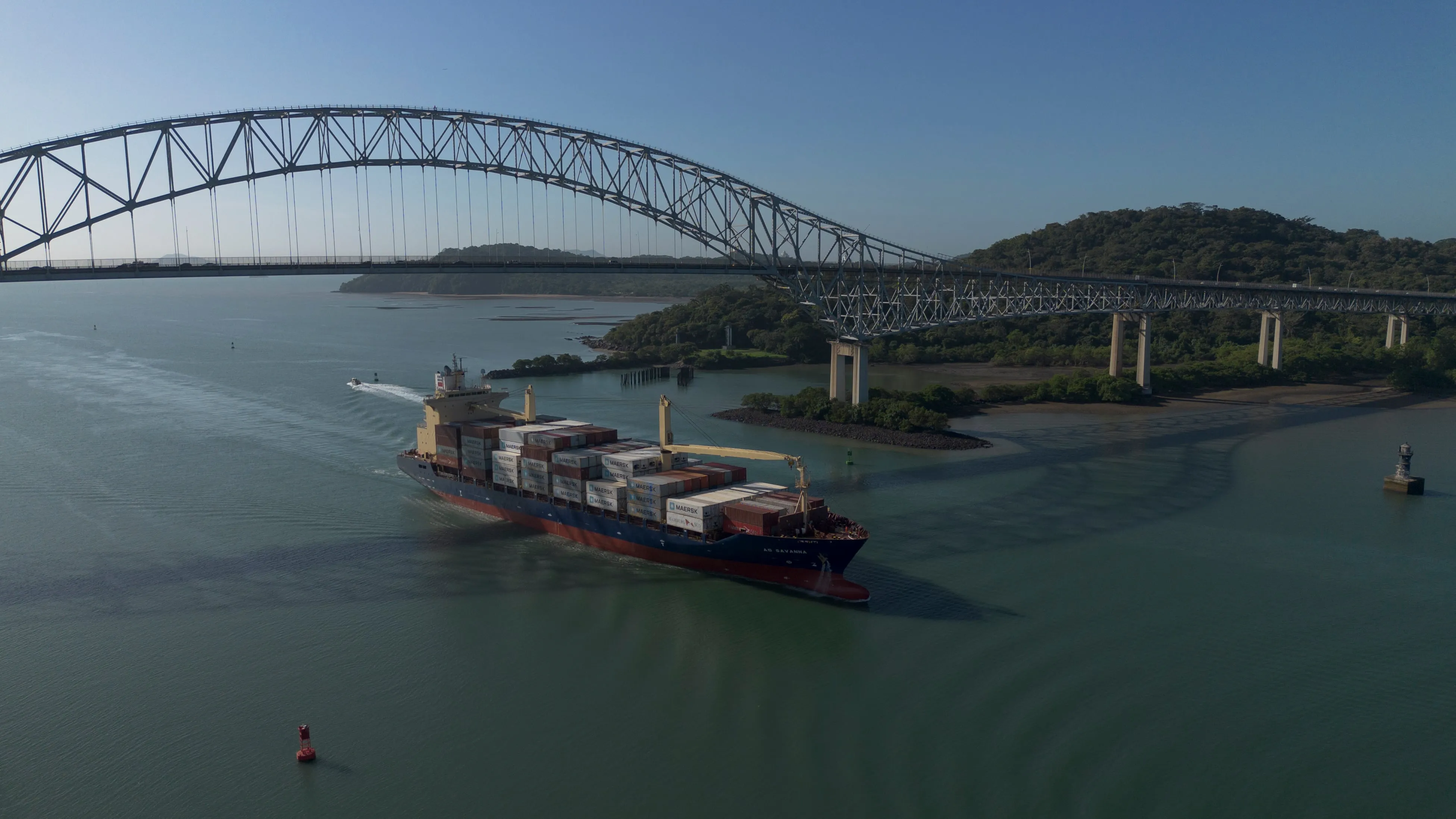 Container ship passes under the bridge of the Americas.